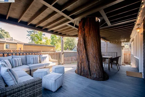 a balcony with furniture and wooden floor