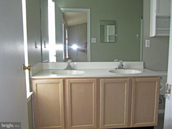107 Bishopstone Circle Frederick, MD 21702 - Photo 11 of 21 a bathroom with a double vanity sink and a mirror