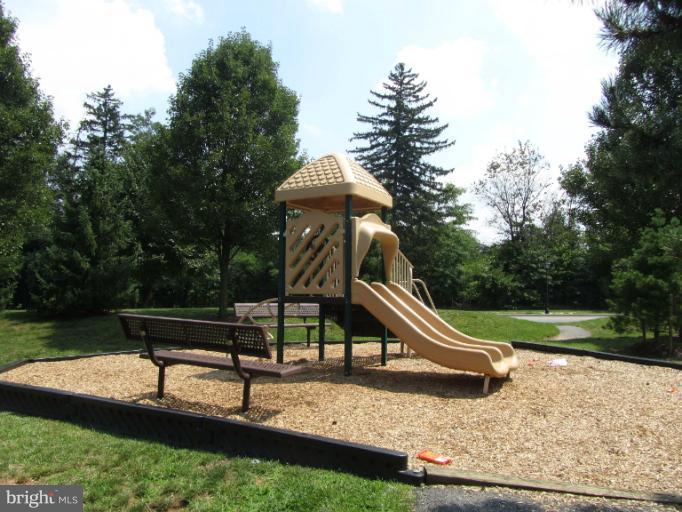 107 Bishopstone Circle Frederick, MD 21702 - Photo 16 of 21 a park view with a bench and trees