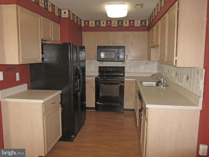 107 Bishopstone Circle Frederick, MD 21702 - Photo 5 of 21 a kitchen with a sink a stove and refrigerator