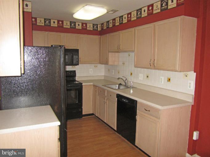 107 Bishopstone Circle Frederick, MD 21702 - Photo 6 of 21 a kitchen with a sink a stove and refrigerator