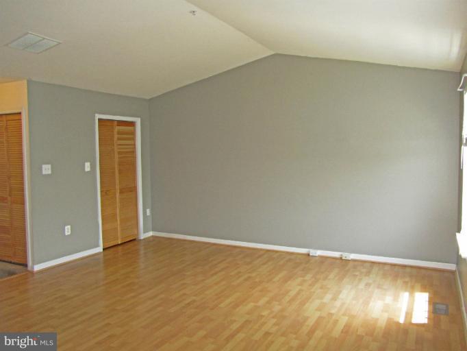 107 Bishopstone Circle Frederick, MD 21702 - Photo 9 of 21 an empty room with wooden floor and windows