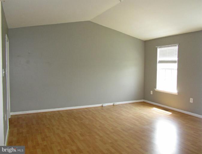 107 Bishopstone Circle Frederick, MD 21702 - Photo 10 of 21 an empty room with wooden floor and windows