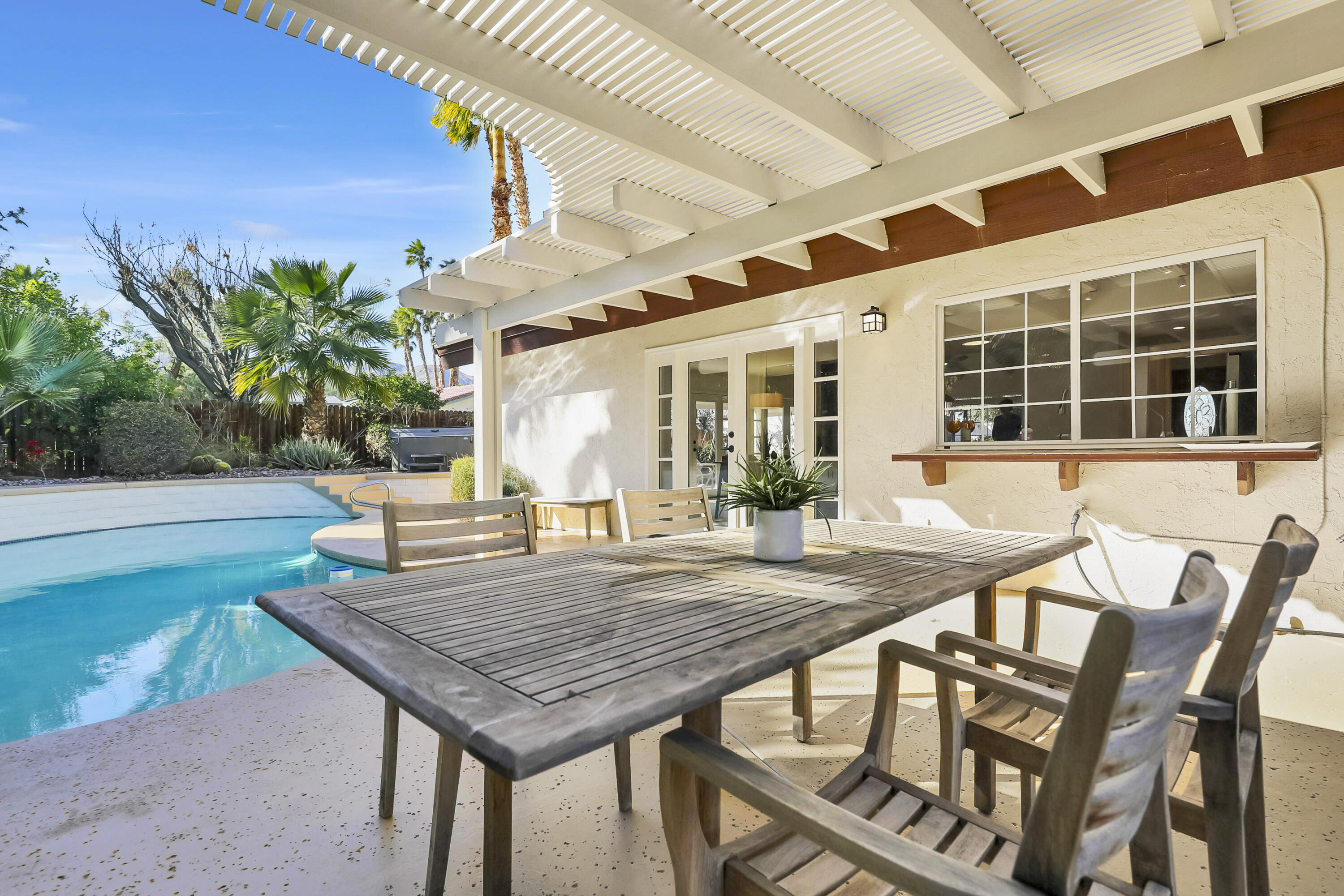 73517 Haystack Road Palm Desert, CA 92260 - Photo 14 of 26 a view of an outside dining space with a table and chairs