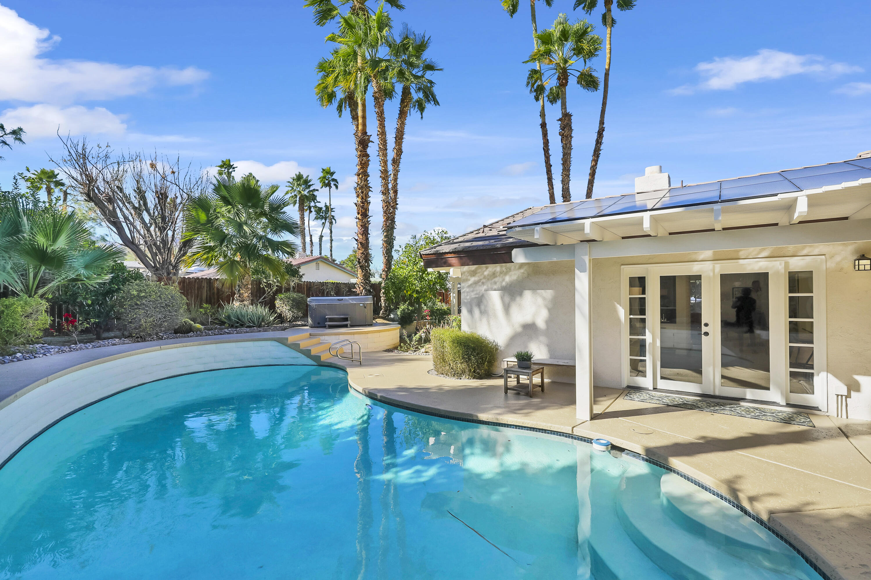 73517 Haystack Road Palm Desert, CA 92260 - Photo 15 of 26 a view of a house with pool and sitting area