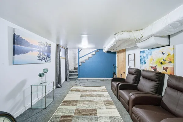 a living room with furniture and a rug