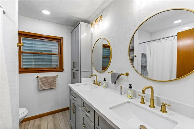 a bathroom with a double vanity sink and a mirror