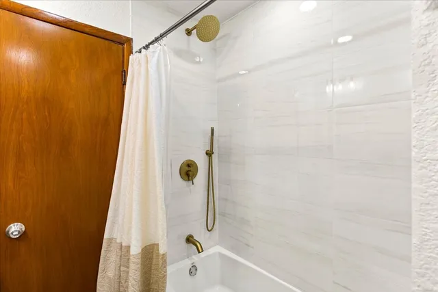 a bathroom with a shower and a tub