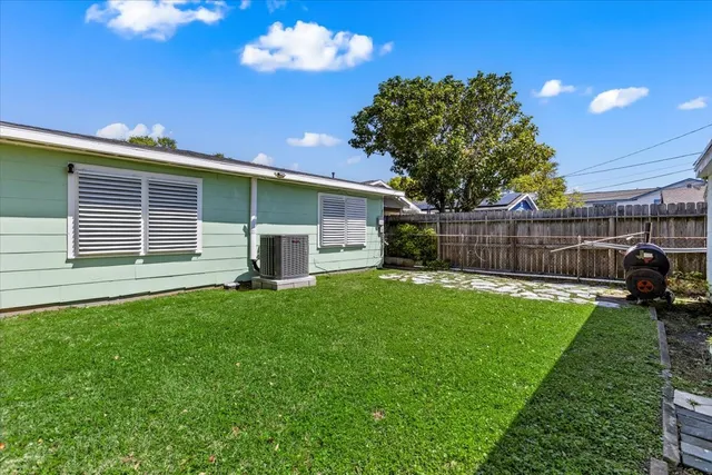 a view of a backyard with a garden and entertaining space