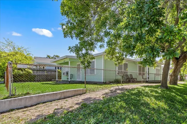 a view of a backyard with a garden and entertaining space