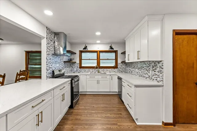 a kitchen with white cabinets and white appliances