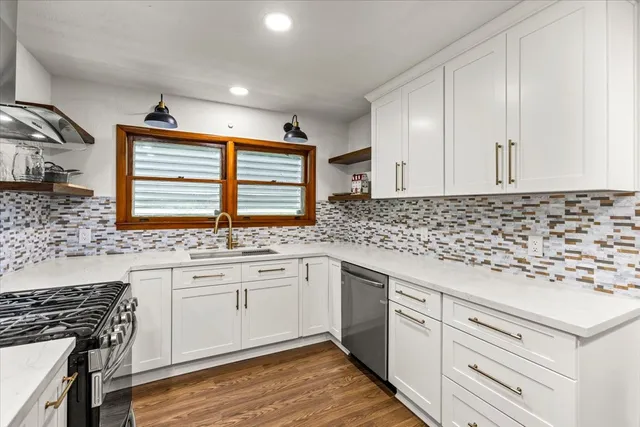 a kitchen with granite countertop white cabinets and white appliances