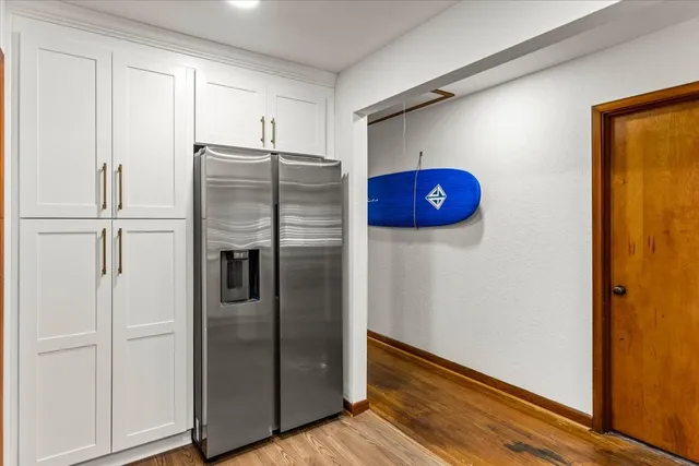 a metallic refrigerator freezer sitting in a kitchen
