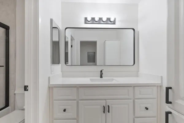 a bathroom with a sink and a mirror