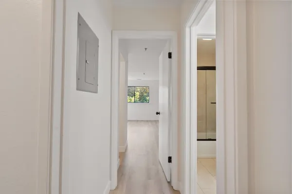 a view of a hallway with wooden floor