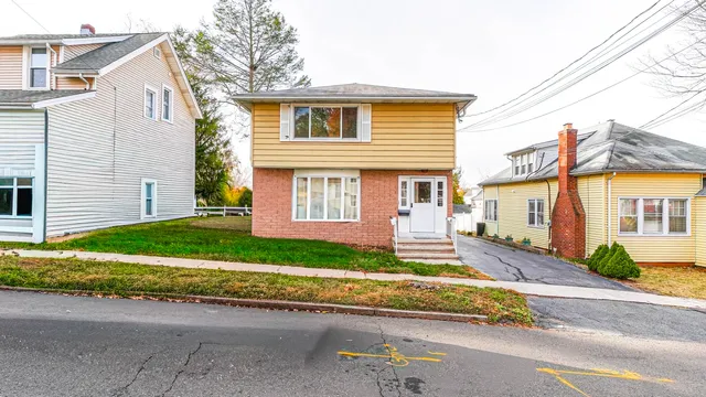 a front view of a house with a yard and outdoor seating