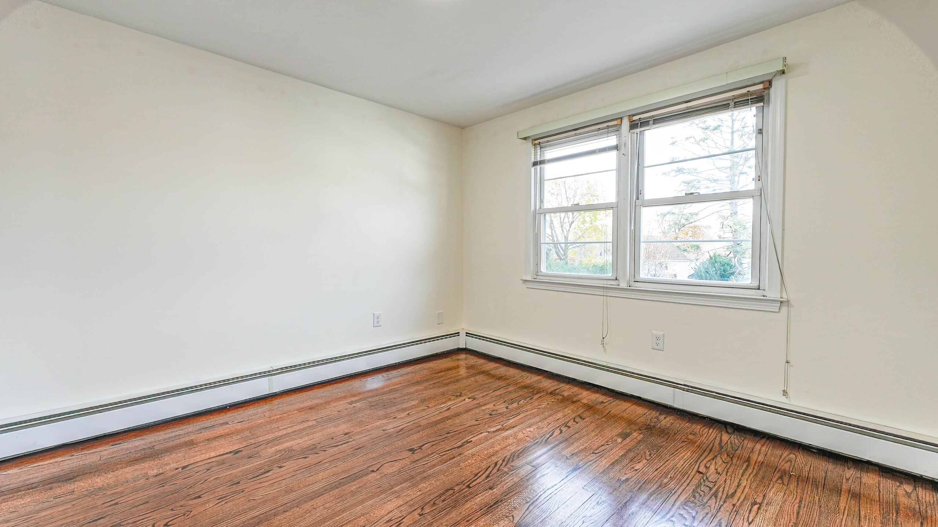 46 Millis Street, Unit 2 Hamden, CT 06514 - Photo 12 of 16 an empty room with wooden floor and windows
