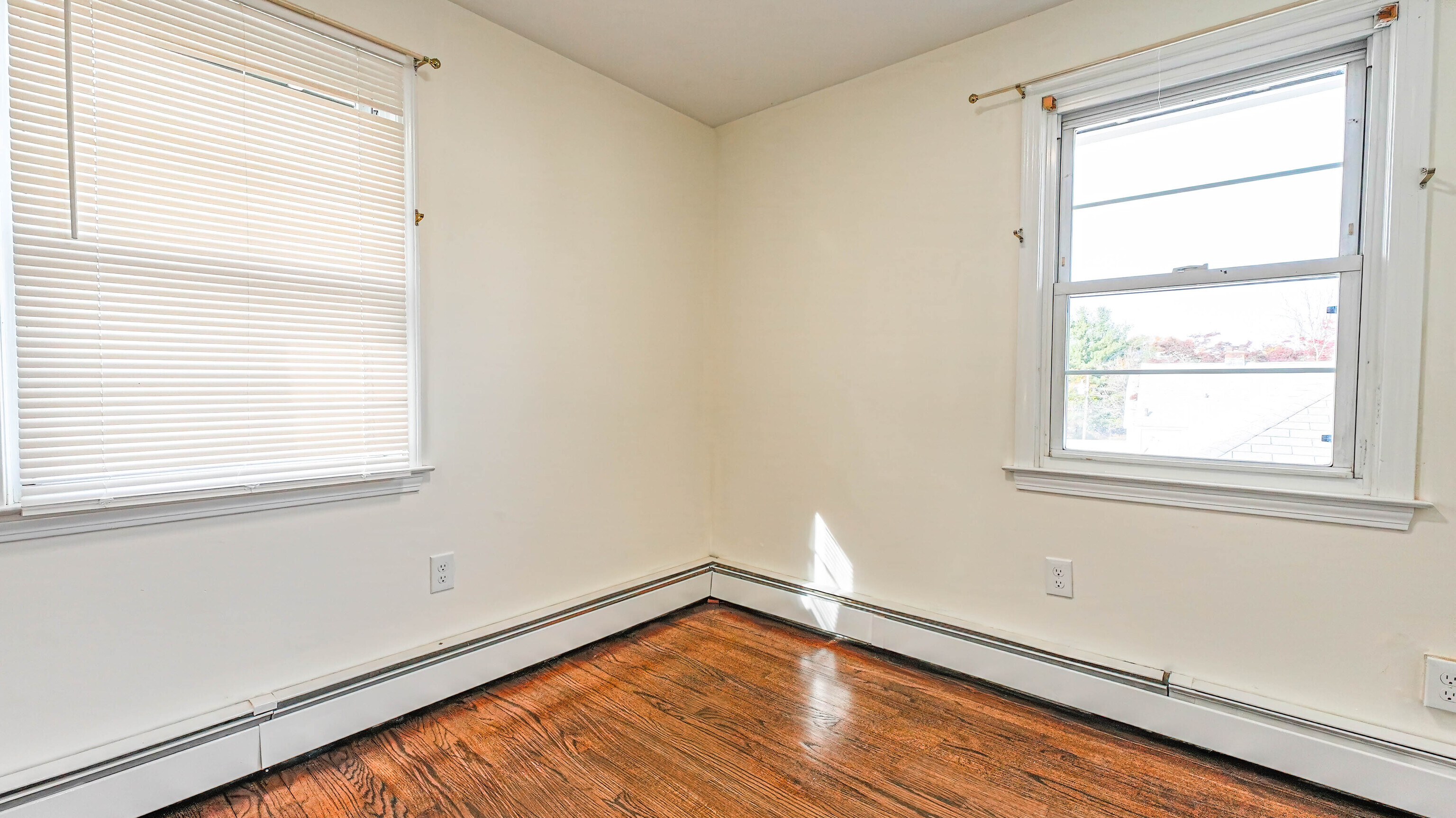 46 Millis Street, Unit 2 Hamden, CT 06514 - Photo 14 of 16 a view of an empty room with wooden floor and a window