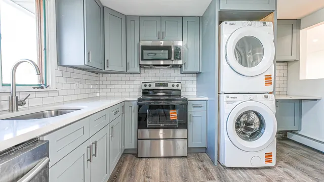 a kitchen with a sink a stove and cabinets