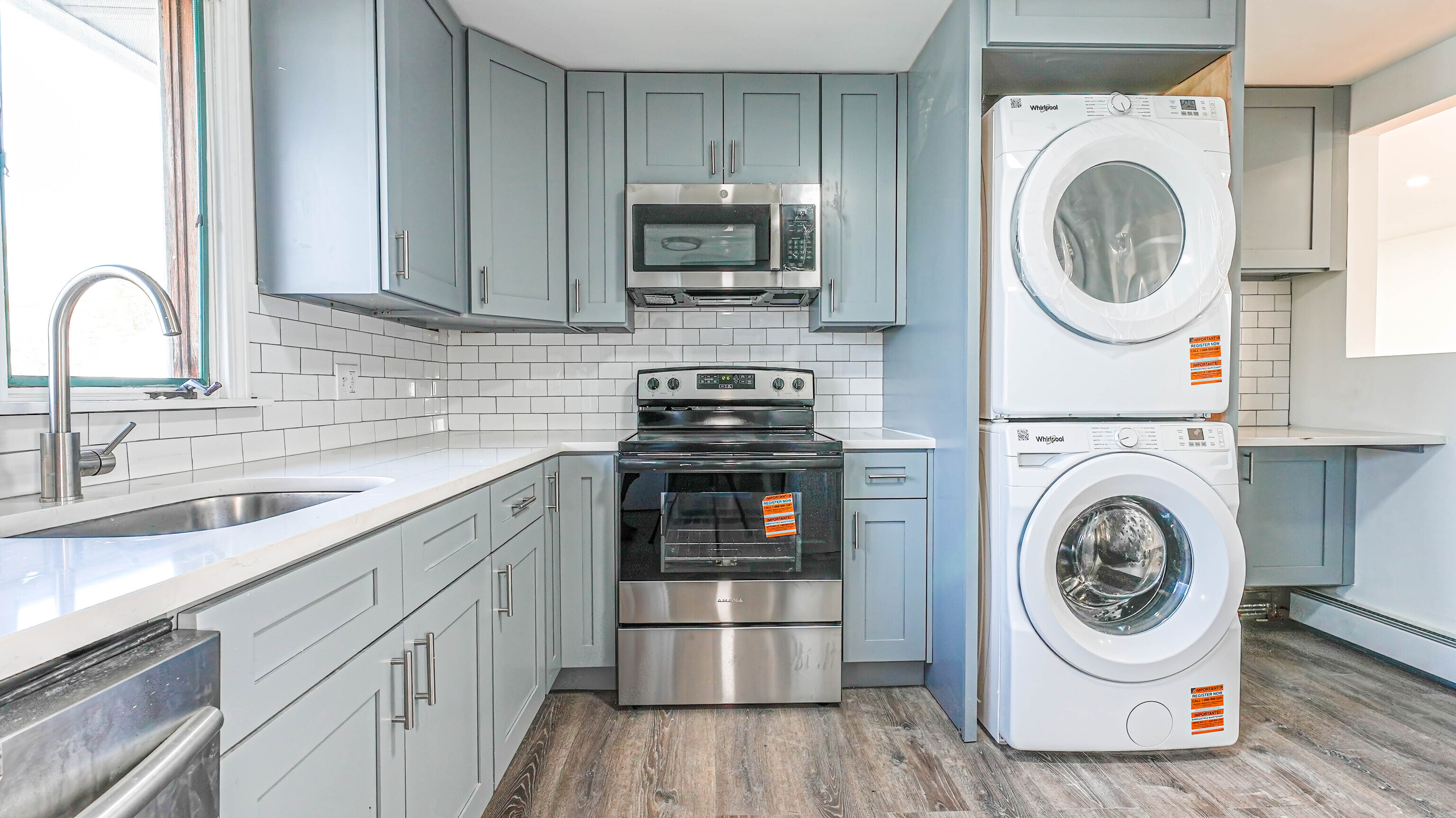 46 Millis Street, Unit 2 Hamden, CT 06514 - Photo 5 of 16 a kitchen with a sink a stove and cabinets