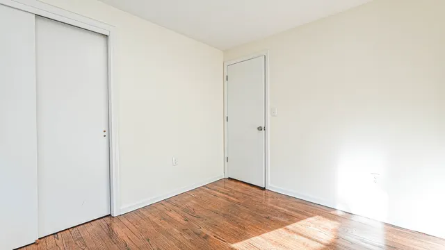 a view of a room with wooden floor