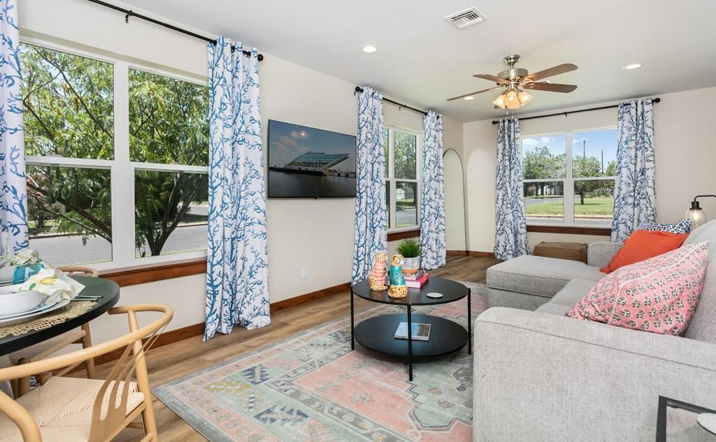 a living room with furniture and a flat screen tv