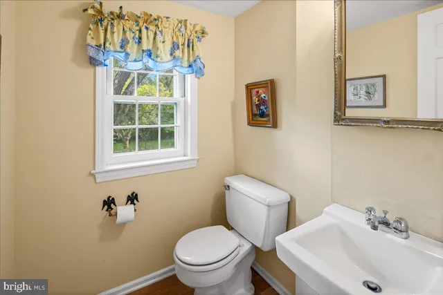 a white toilet sitting next to a bathroom sink