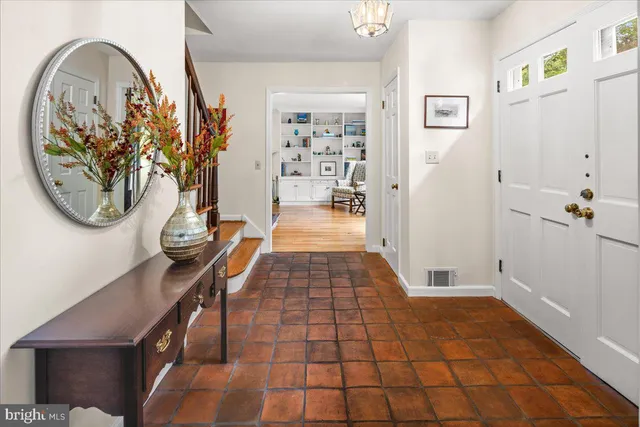 a bedroom with a bed a dresser and a window