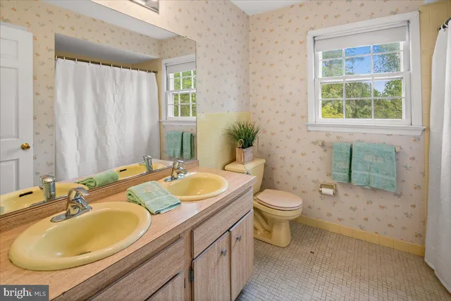 a view of a room with wooden floor and a window