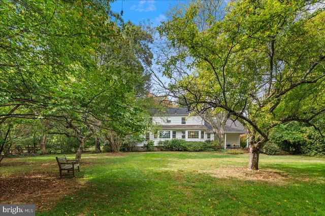 a view of a bench in backyard of house