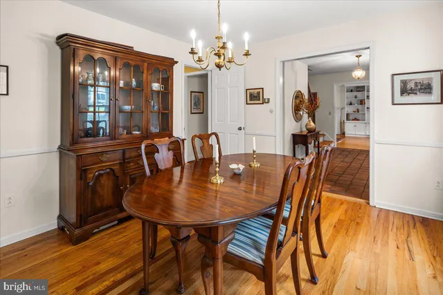 a view of a dining room with furniture and chandelier