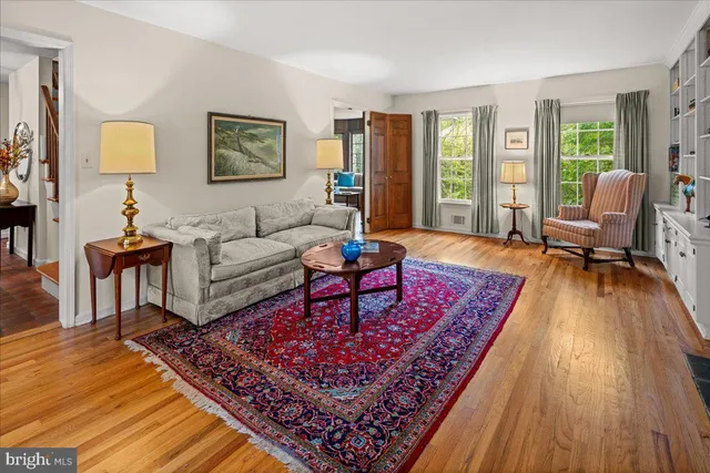 a living room with furniture rug and wooden floor