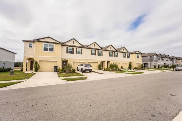a view of a house with backyard and sitting area