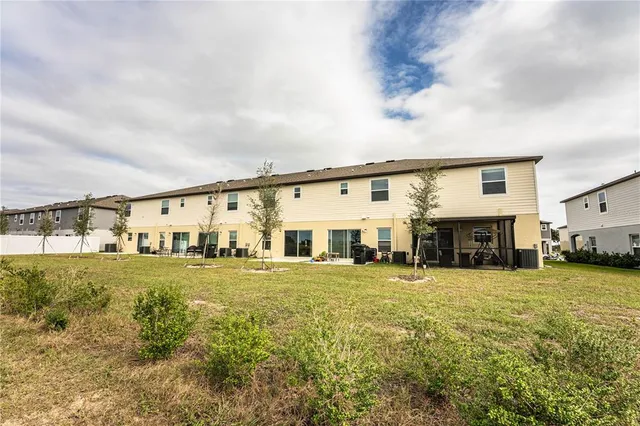 a living room with furniture kitchen view and a flat screen tv