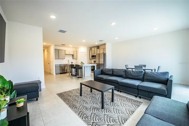 a kitchen with stainless steel appliances a stove microwave and a refrigerator
