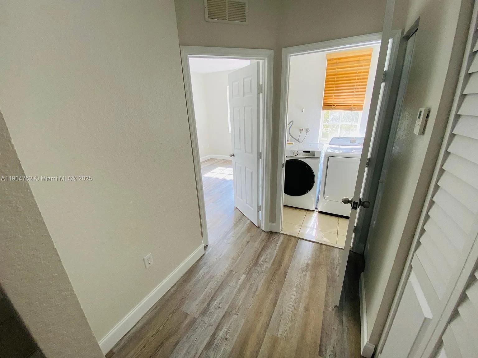4947 Southwest 135th Way Miramar, FL 33027 - Photo 2 of 17 a view of a porch with wooden floor