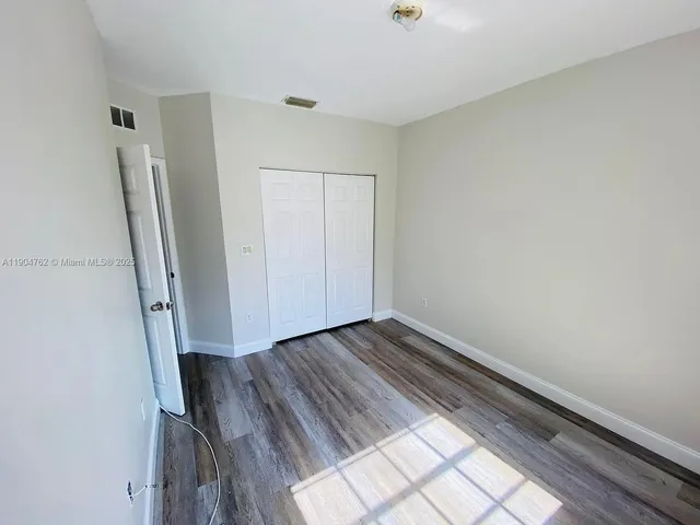 a view of a room with wooden floor and staircase
