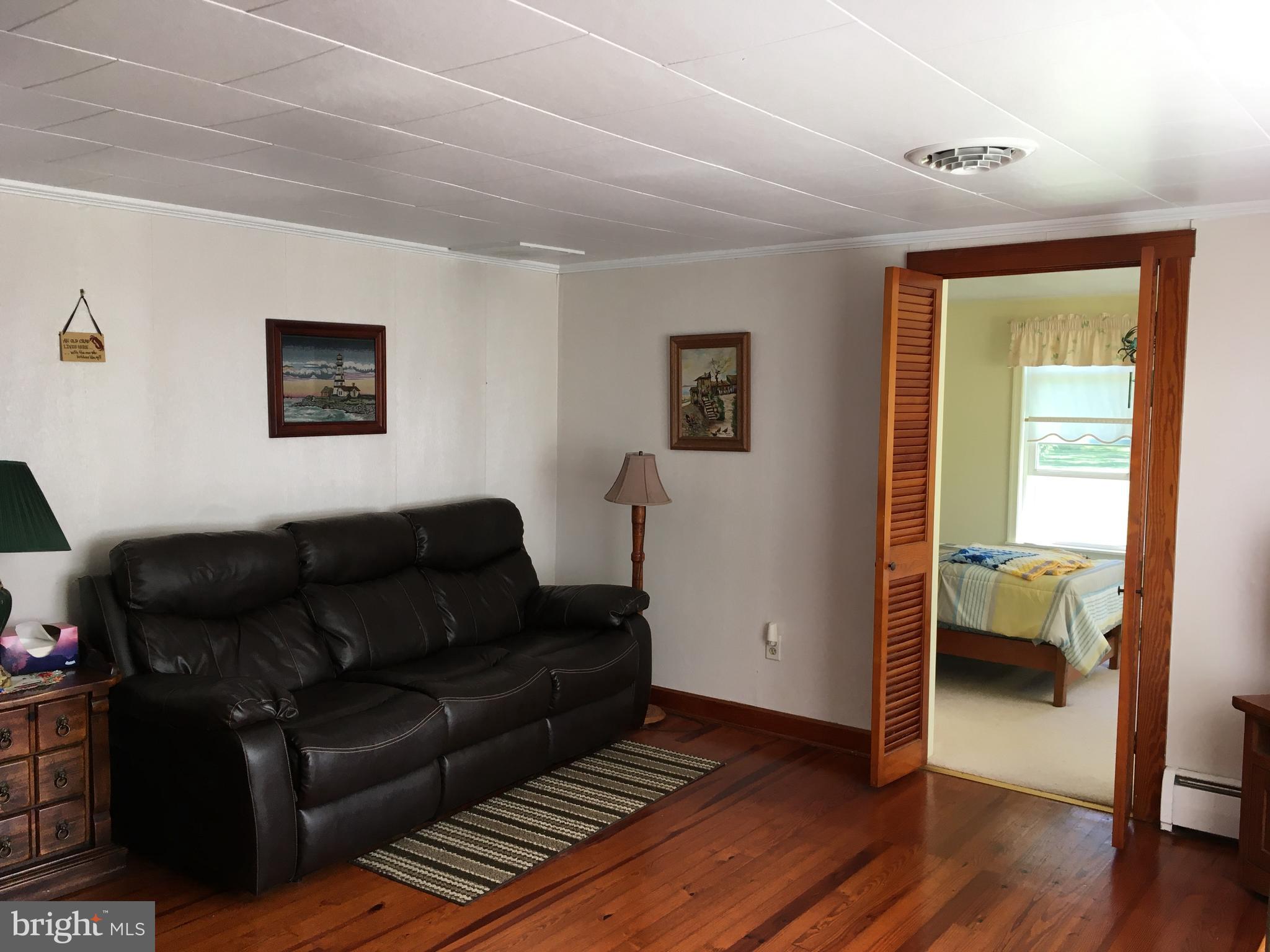 4849 Skinners Neck Road Rock Hall, MD 21661 - Photo 13 of 21 Living room & doorway to bedroom 3