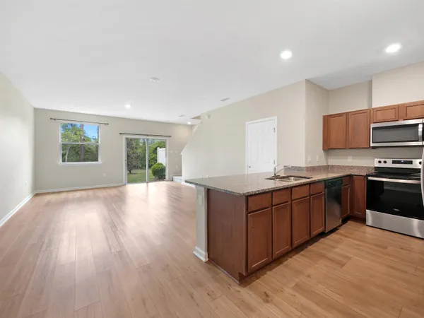 a kitchen with stainless steel appliances granite countertop a stove a sink and a refrigerator