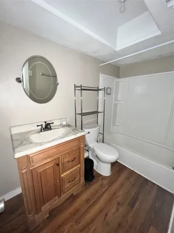 a bathroom with a granite countertop toilet sink and a mirror