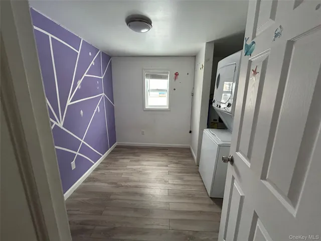 a view of a hallway with wooden floor and entryway