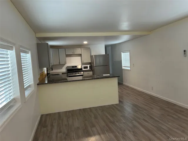 a view of kitchen with sink and wooden floor