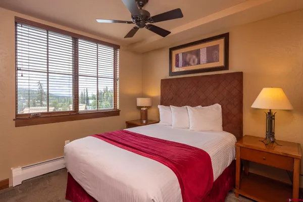 a bedroom with two beds and a window