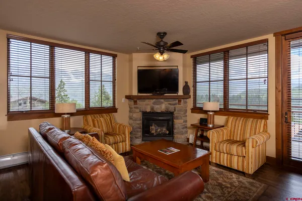 a kitchen with stainless steel appliances granite countertop a table chairs refrigerator and microwave