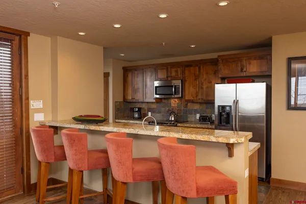 a large kitchen with dining table and chairs