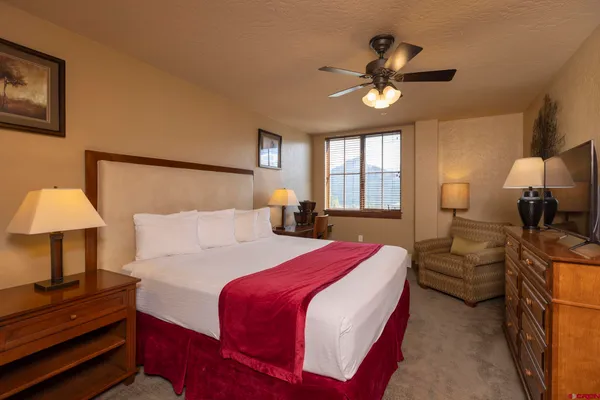 a bedroom with a large bed and a window