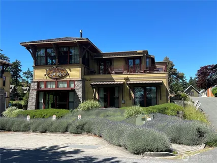 a front view of a house with a garden