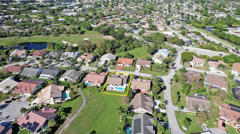 an aerial view of residential houses with outdoor space and street view