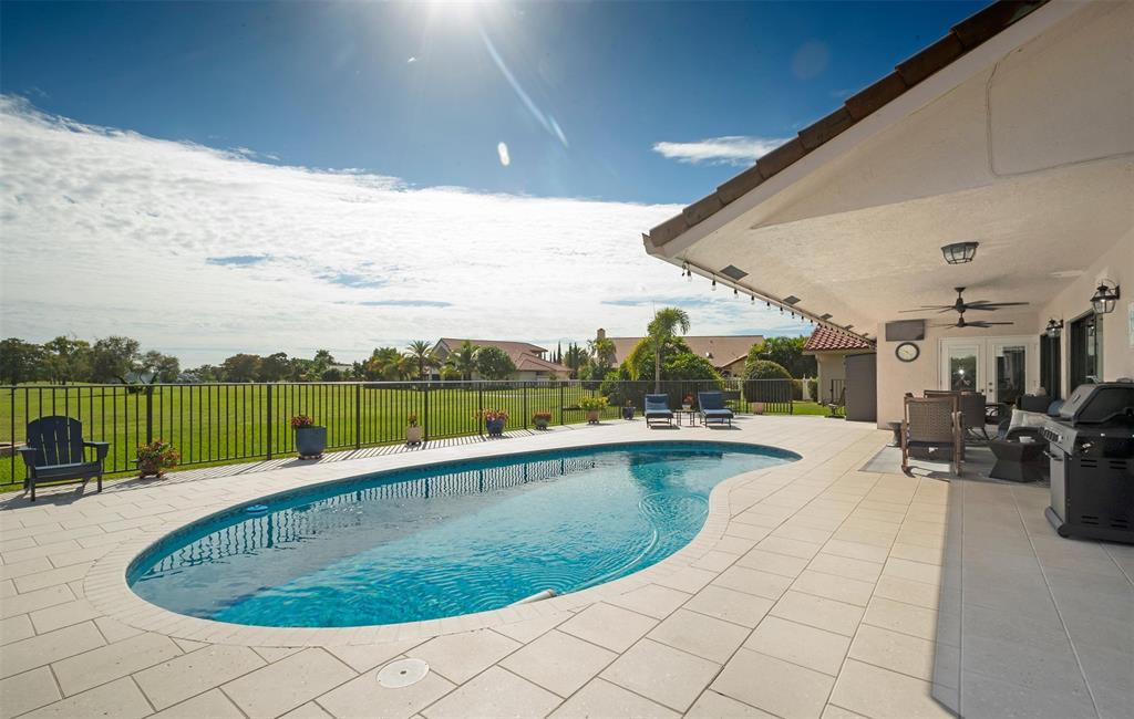 7810 Northwest 87th Avenue Tamarac, FL 33321 - Photo 19 of 21 a view of a swimming pool and lounge chair