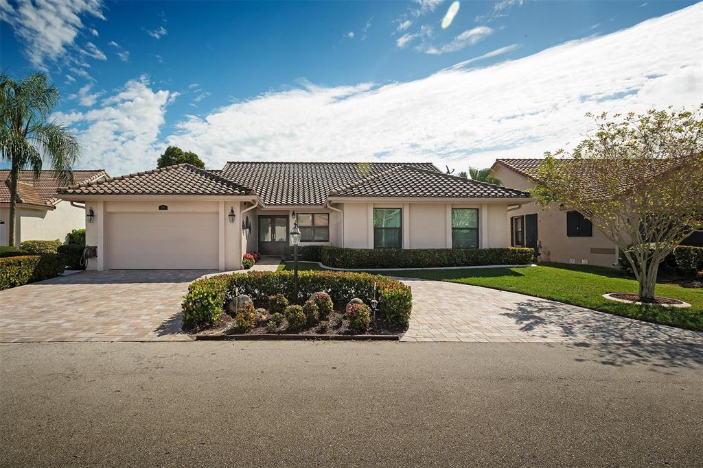 7810 Northwest 87th Avenue Tamarac, FL 33321 - Photo 2 of 21 a front view of a house with a garden